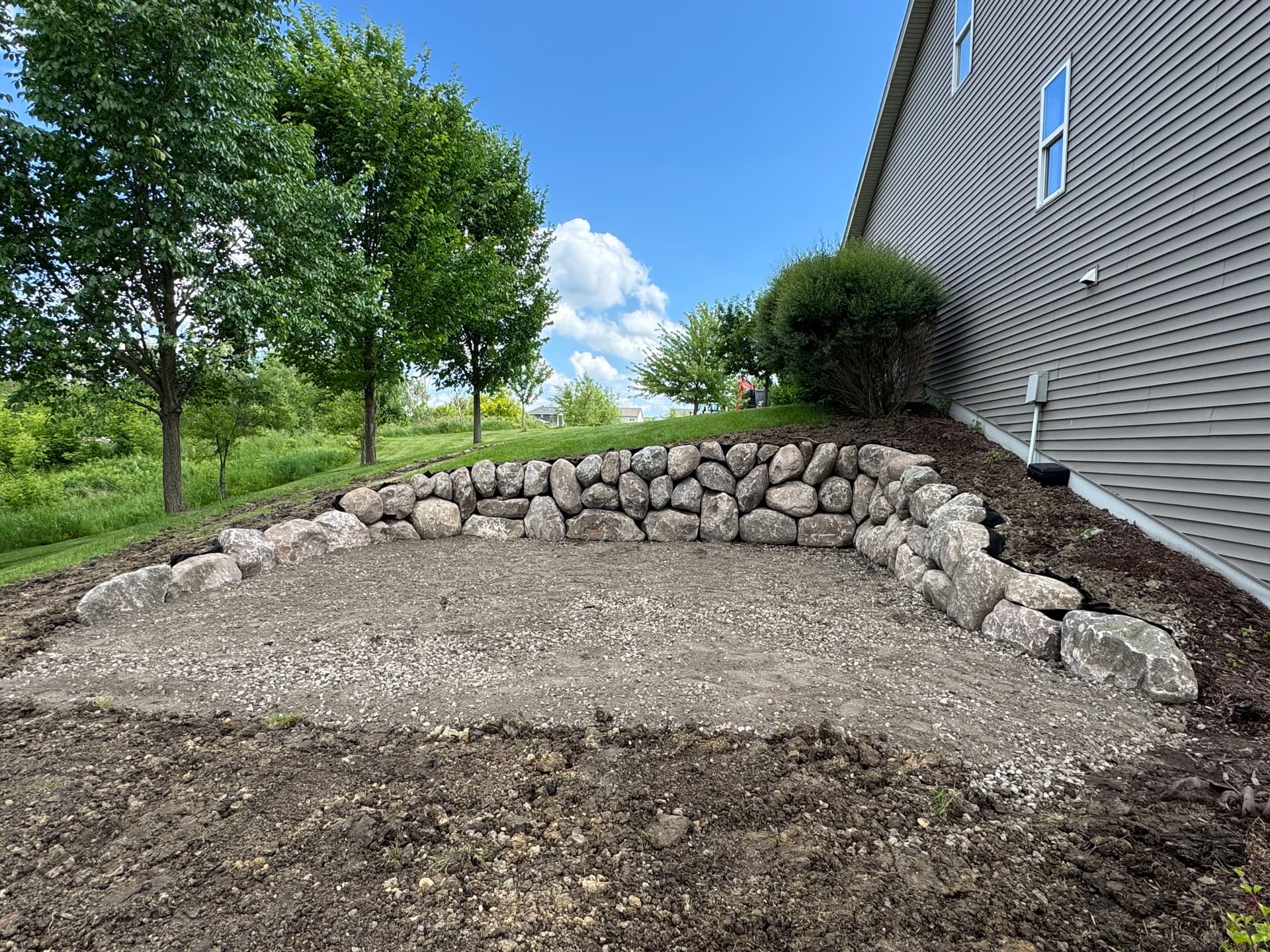 Hillside Excavation and Boulder Retaining Wall for Shed Pad