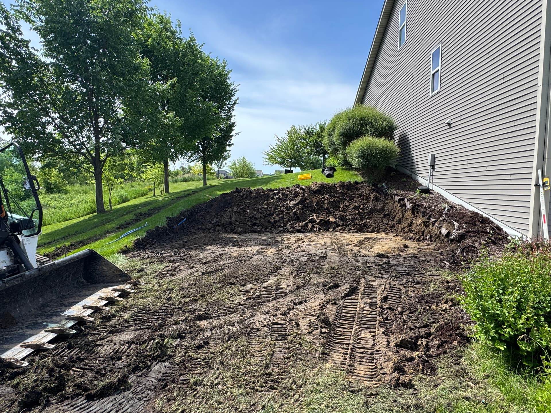 Hillside Excavation and Boulder Retaining Wall for Shed Pad