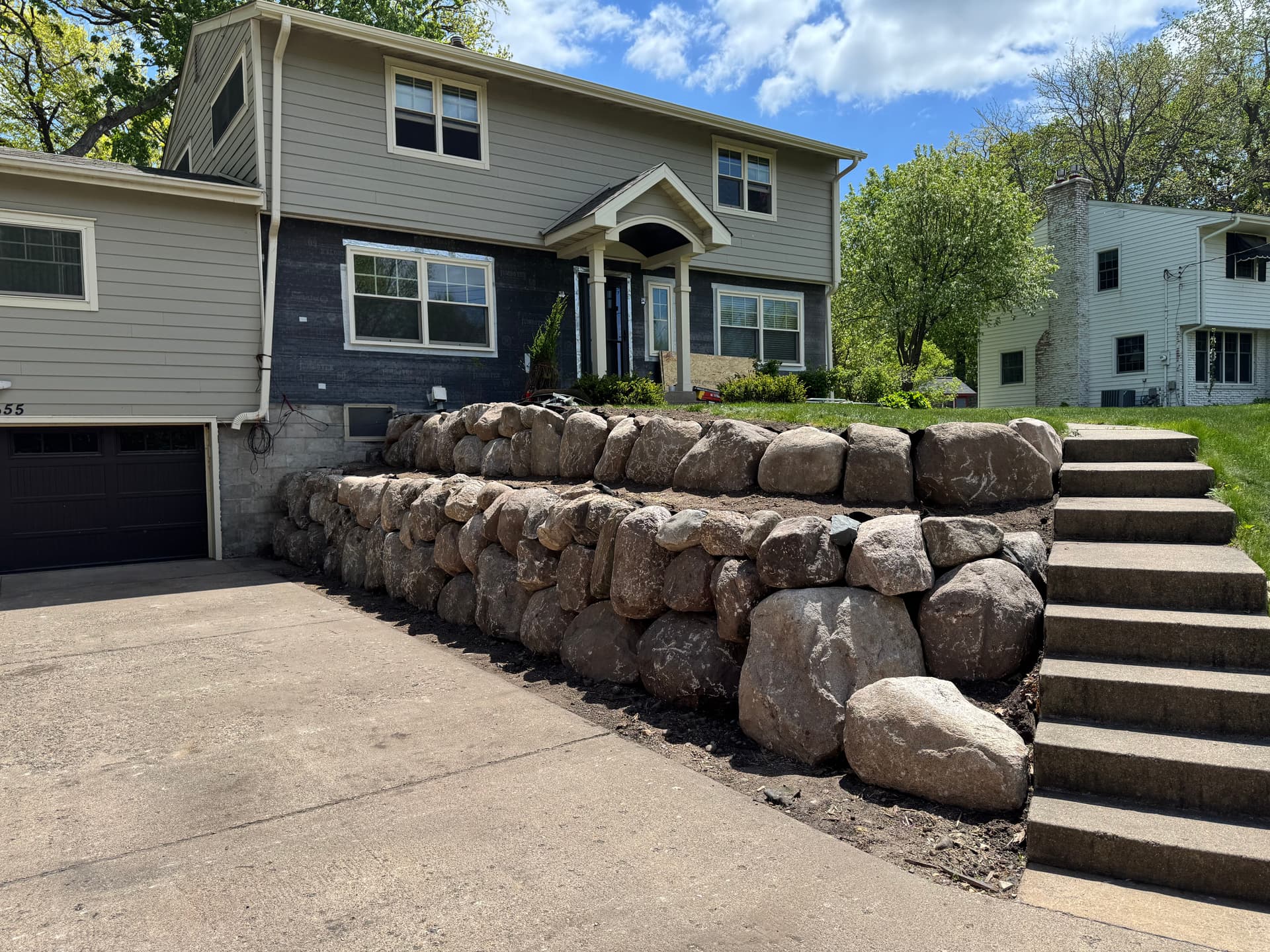 Failing Timber Wall Replaced with Boulder Retaining Wall in Wayzata image